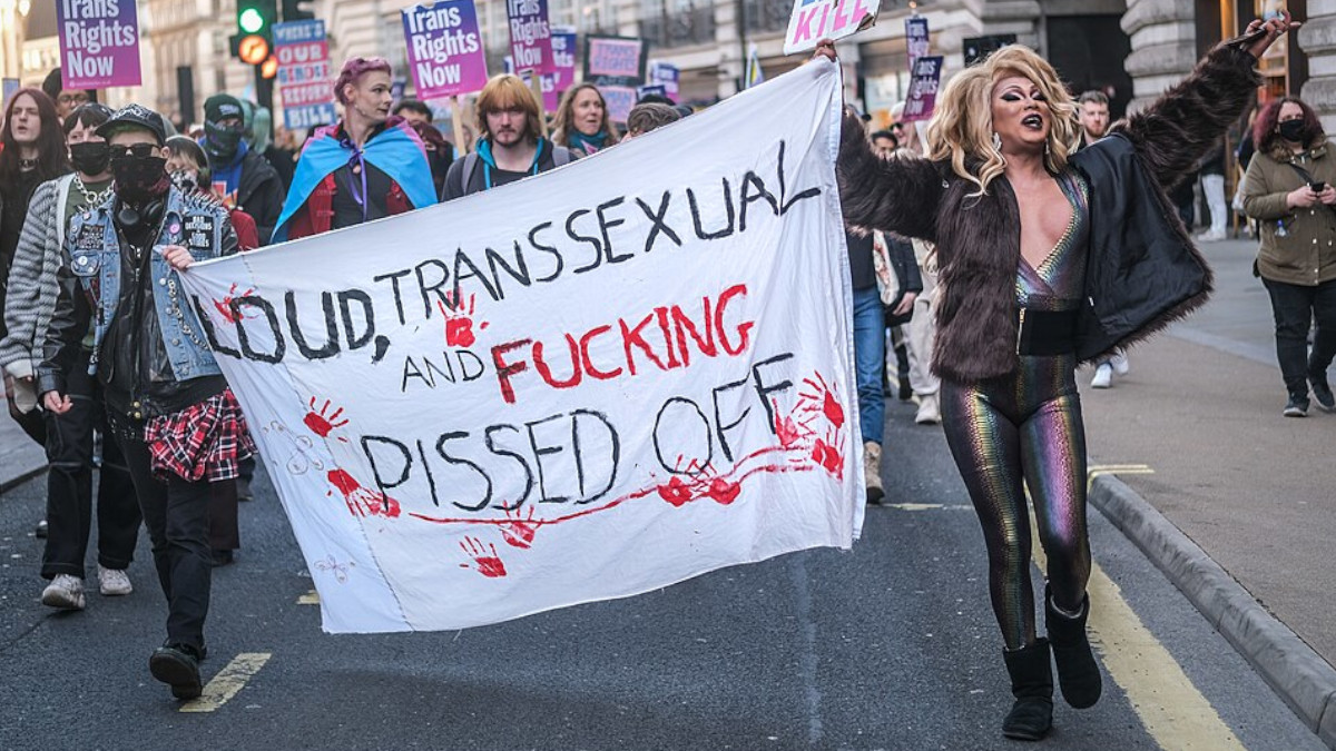 Trans rights protest with sign saying "Loud Transsexual"
